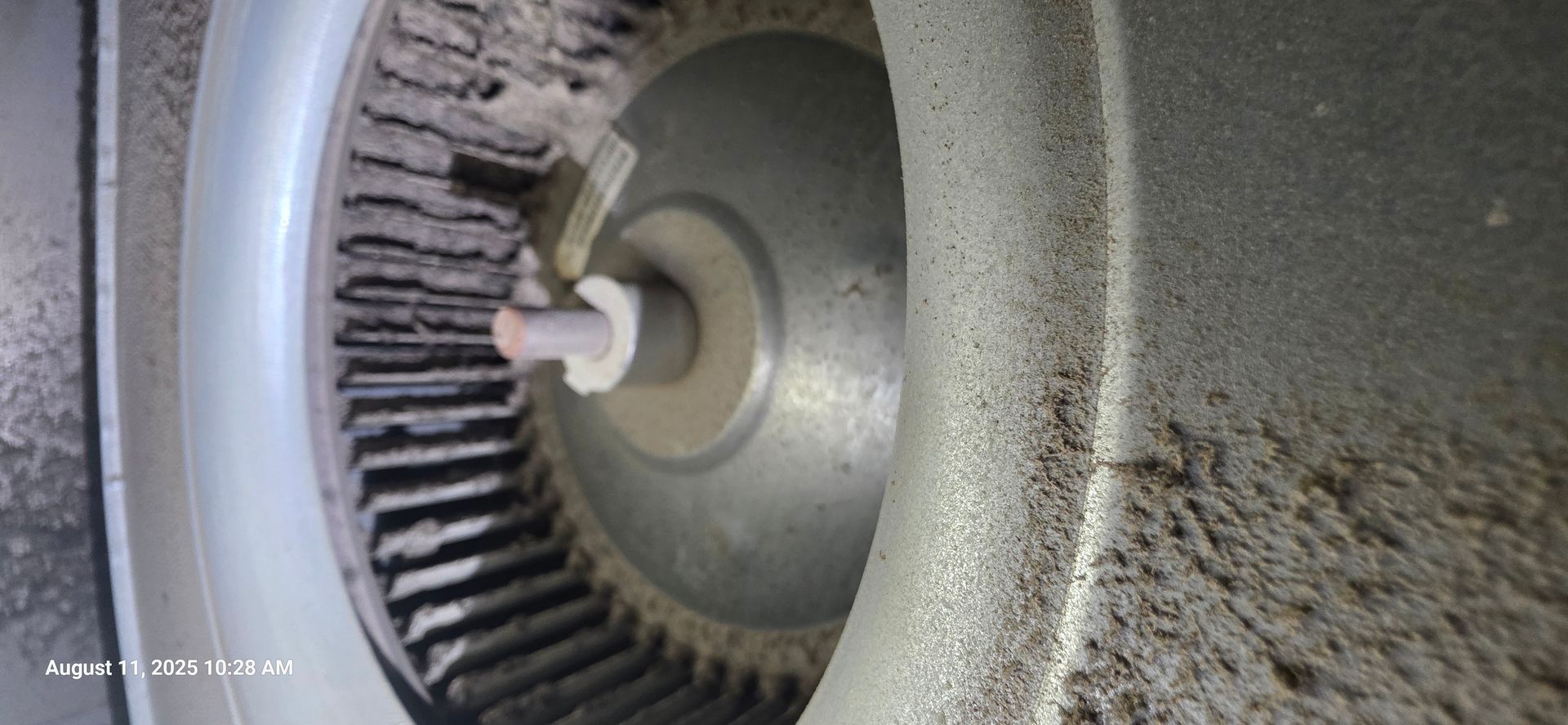 Close-up of a dusty fan, likely for an air conditioner or heating system.