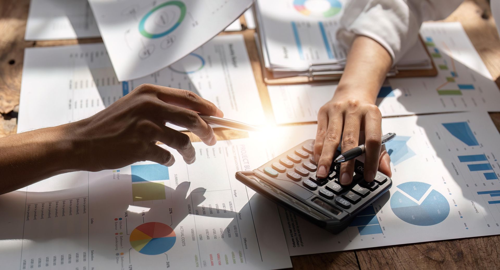 Two financial advisers working on a financial report.