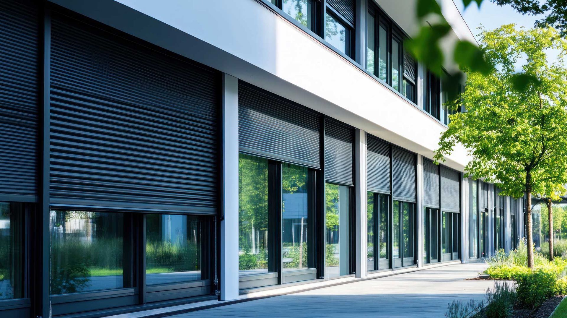 View of several black commercial roller shutters in a store outside