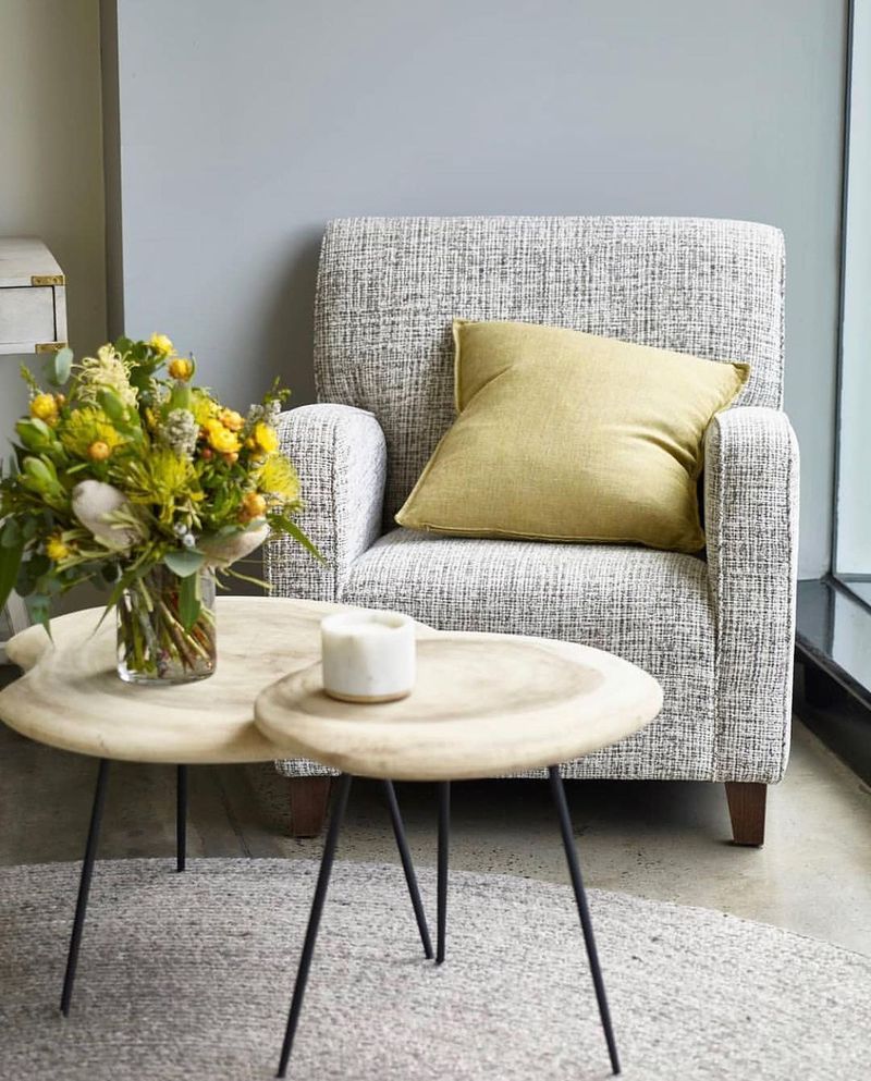 A Chair With Patterned Fabric, a Yellow Pillow, and a Small Table — Hastings Specialty Furniture In Port Macquarie, NSW