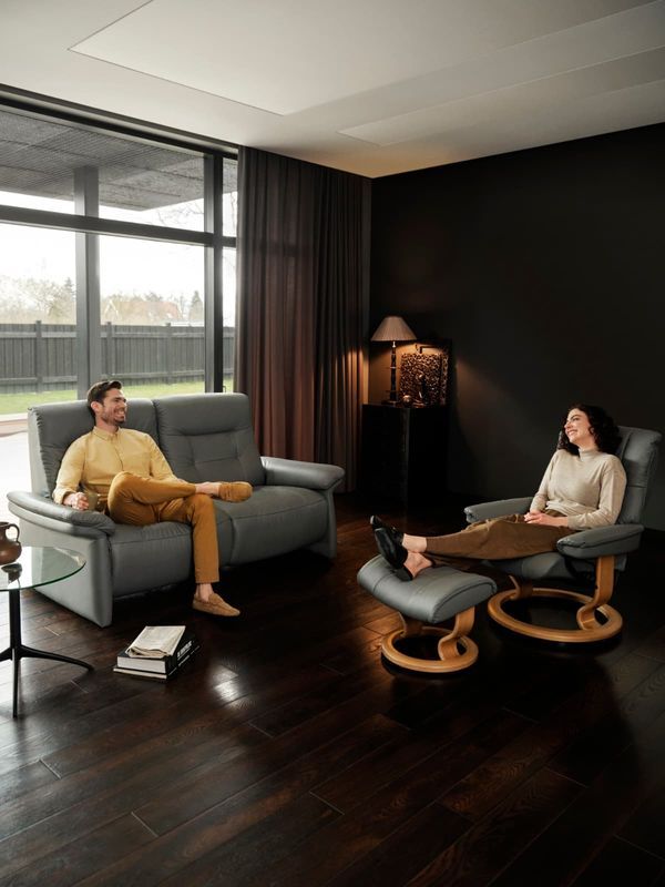 Man and Woman Relax in a Modern Living Room — Hastings Specialty Furniture In Port Macquarie, NSW