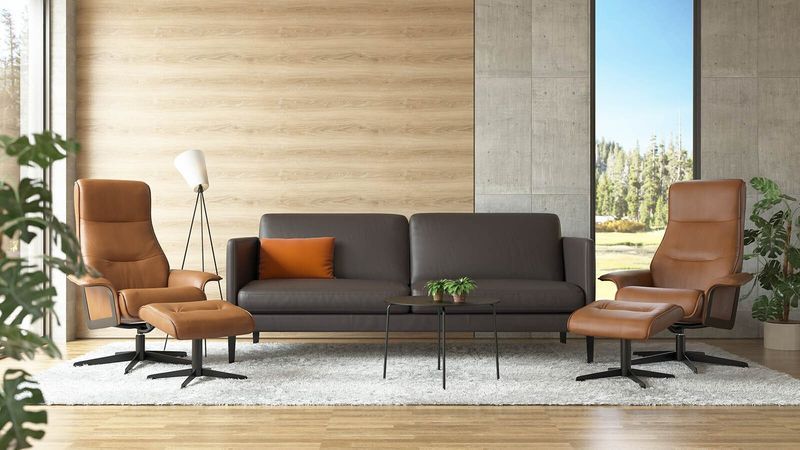 Living Room With Brown Leather Sofa, Matching Chairs, and Rug — Hastings Specialty Furniture In Port Macquarie, NSW