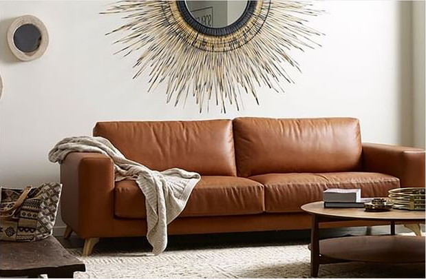 Brown Leather Sofa in a Living Room, With a Blanket — Hastings Specialty Furniture In Port Macquarie, NSW
