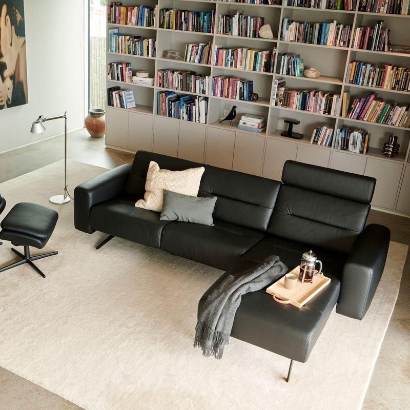 Black Leather Sectional Sofa in a Living Room — Hastings Specialty Furniture In Port Macquarie, NSW