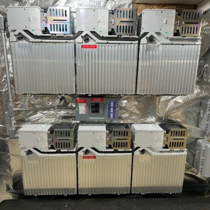 A bunch of batteries are stacked on top of each other on a wall.