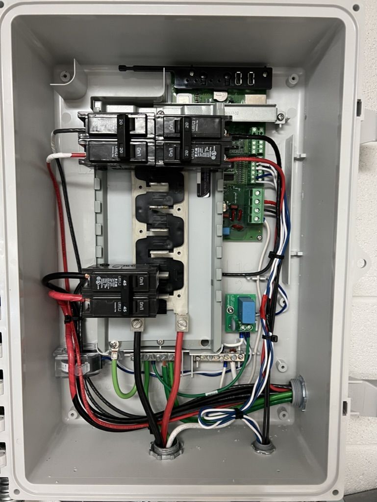 The inside of a box with a lot of wires coming out of it