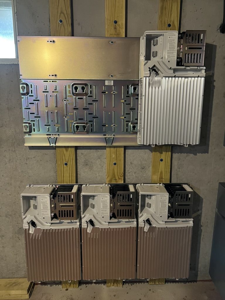 A bunch of electrical equipment is hanging on a wall.