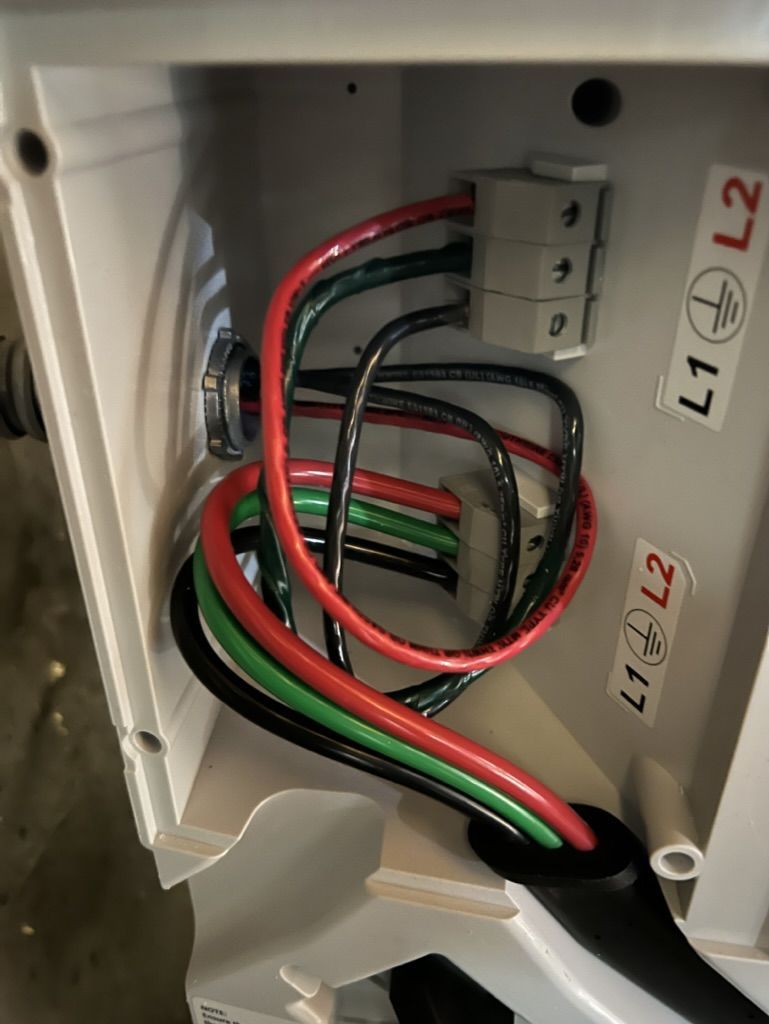 A white box with a bunch of wires coming out of it