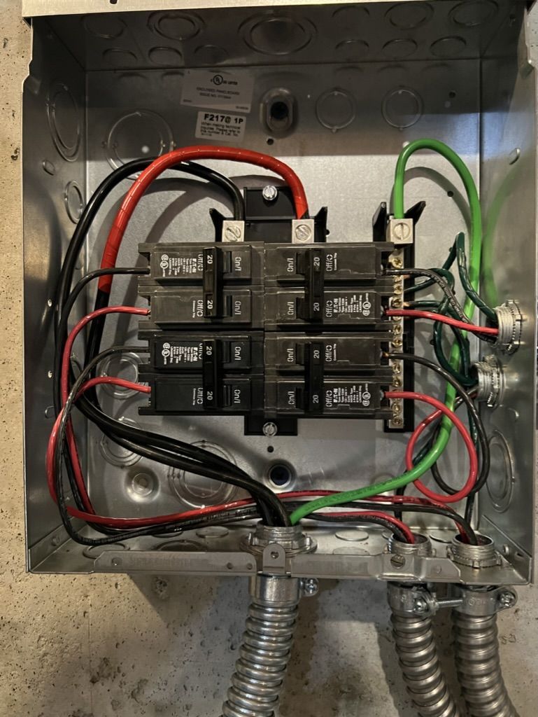 A close up of a electrical box with wires coming out of it.