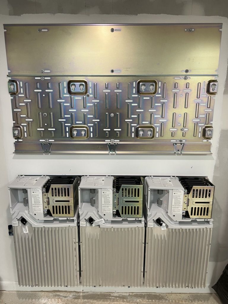 A wall with a bunch of electrical boxes on it.