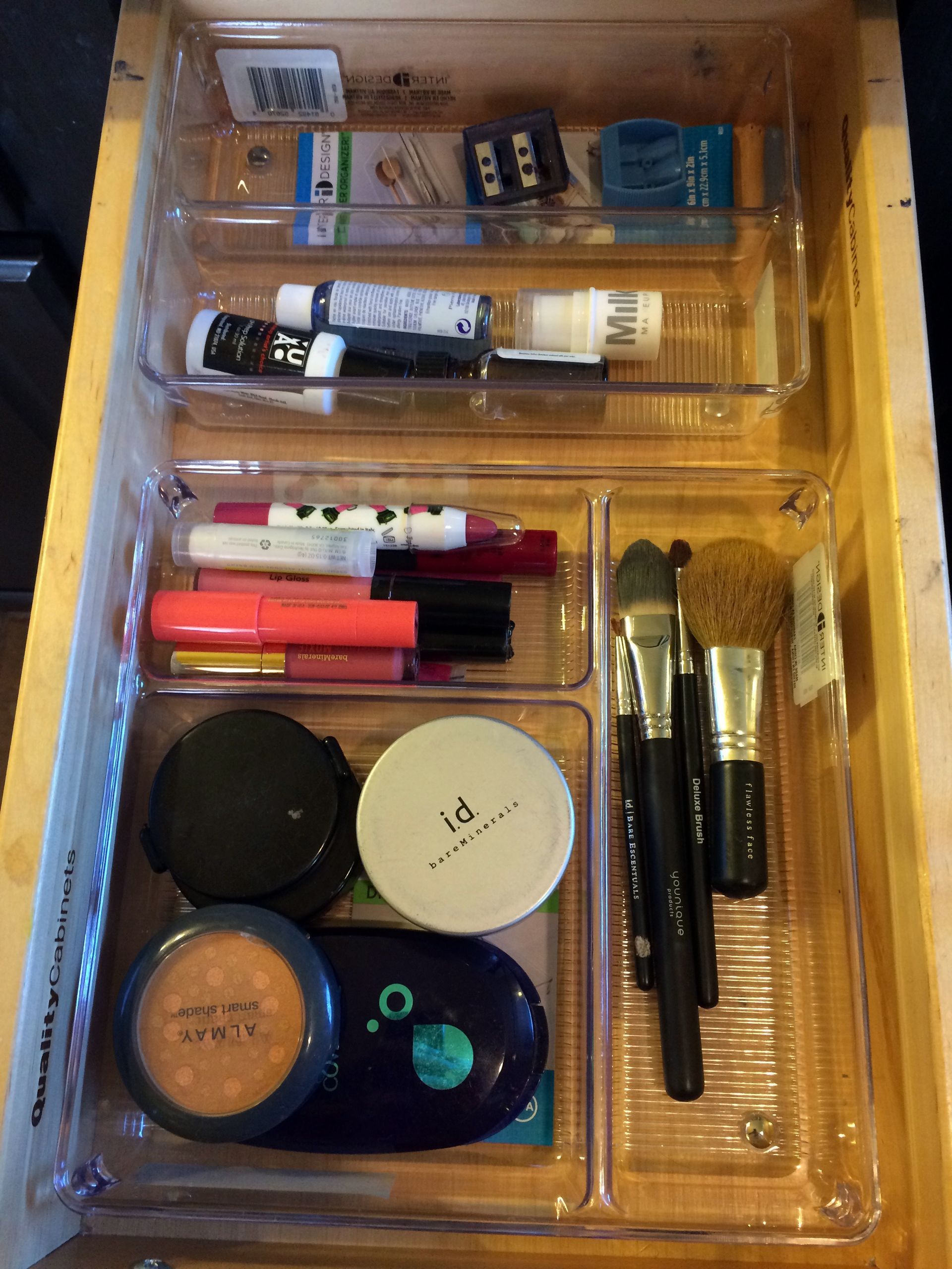 A drawer filled with cosmetics and makeup brushes