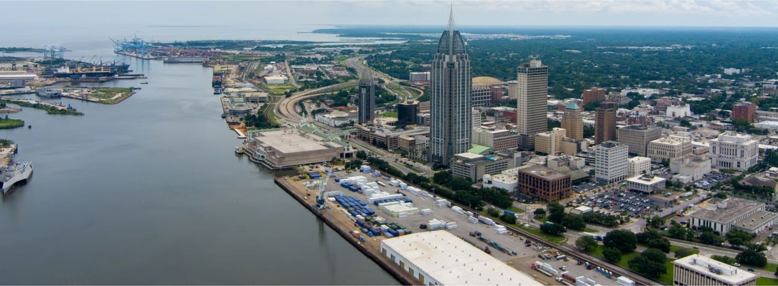 Two cars involved in a collision on a city street; one is dark blue, the other is gray.