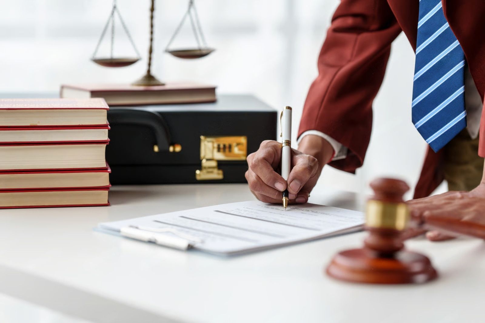 Two cars involved in a collision on a city street; one is dark blue, the other is gray.