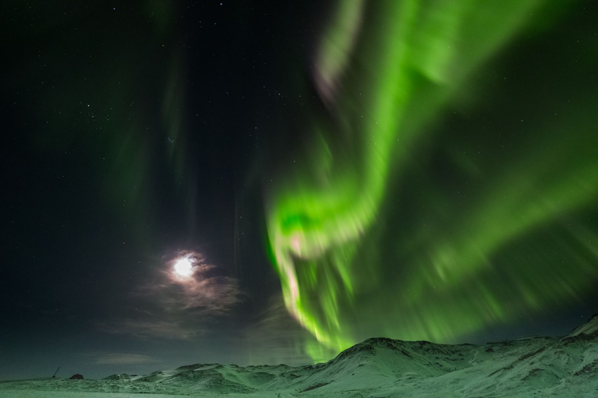 Pouring champagne by the scenic mountains on the Snæfellsnes peninsula in Iceland.