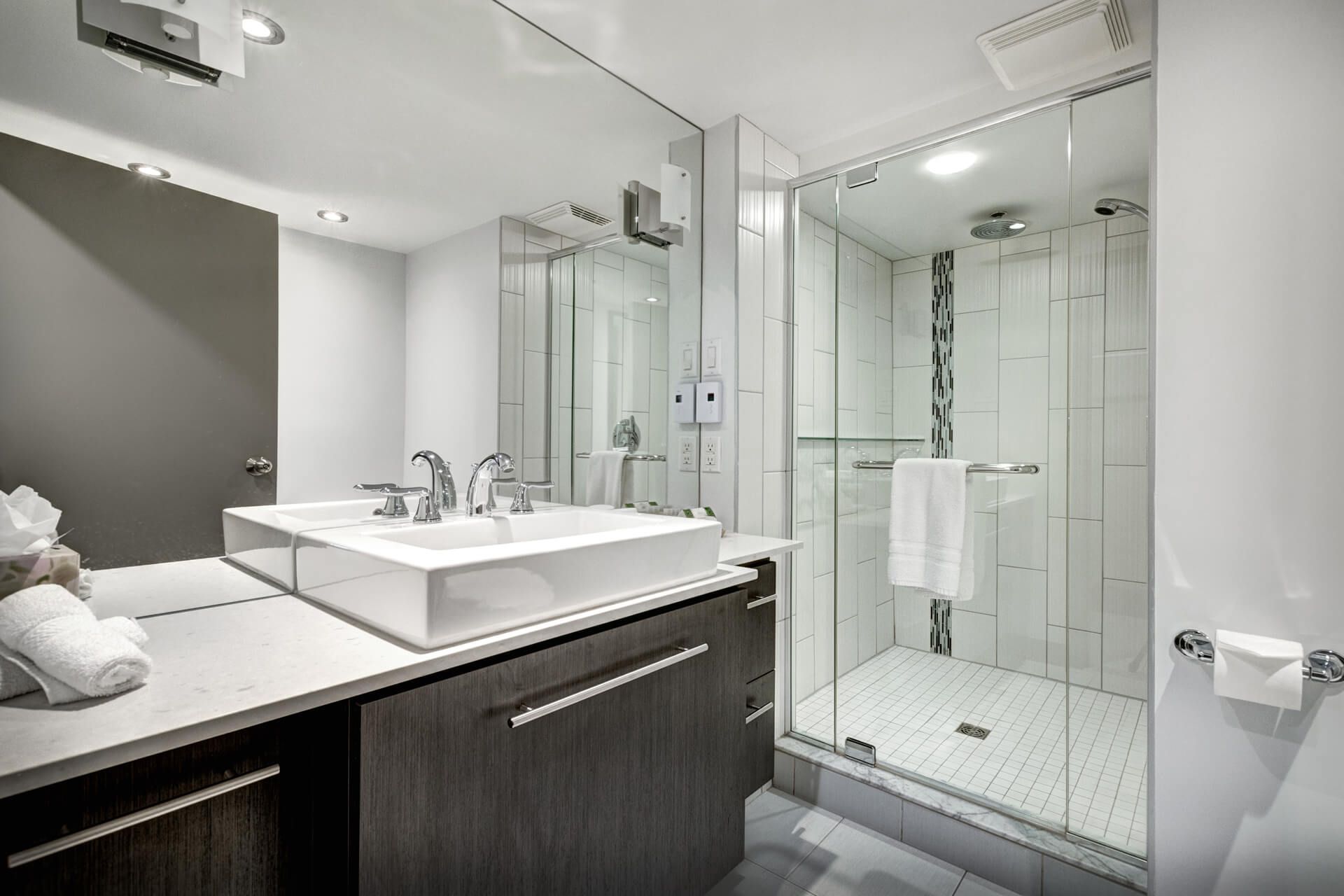 A bathroom with a sink and a walk-in shower