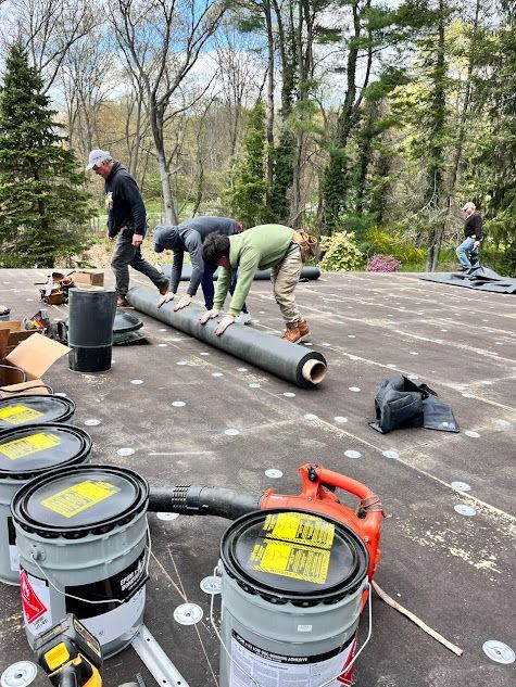 A group of people are working on a roof.