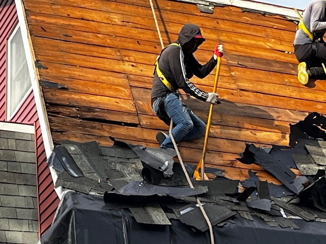 A man is working on the roof of a house