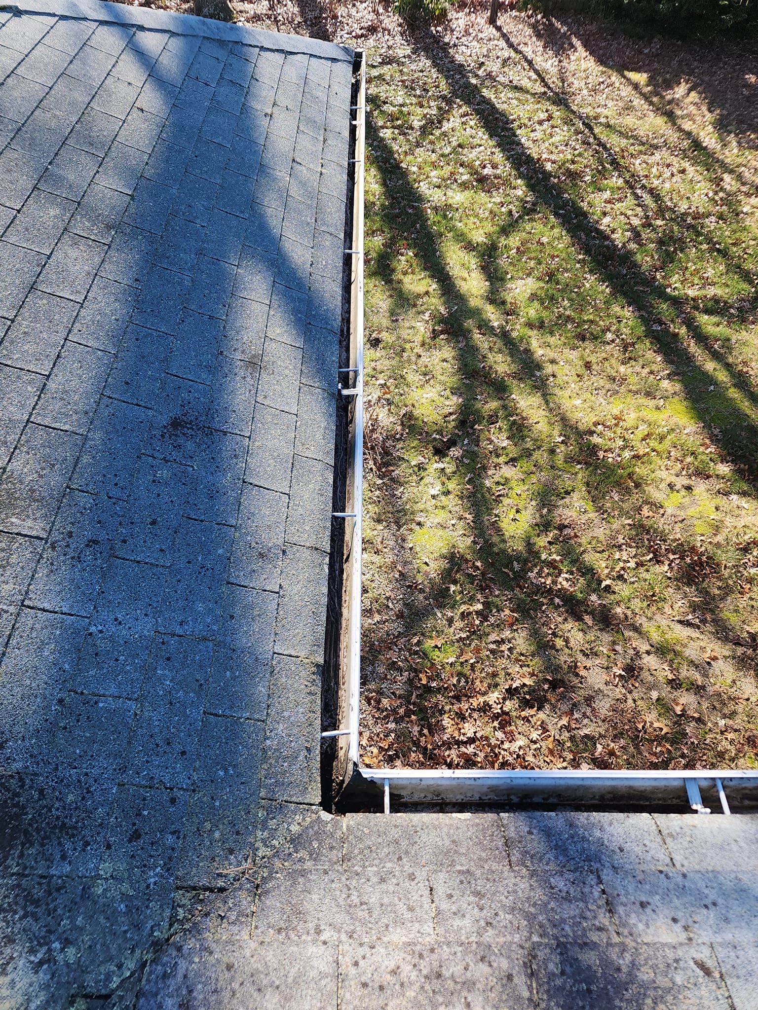 A close up of a gutter on a roof after cleaning.