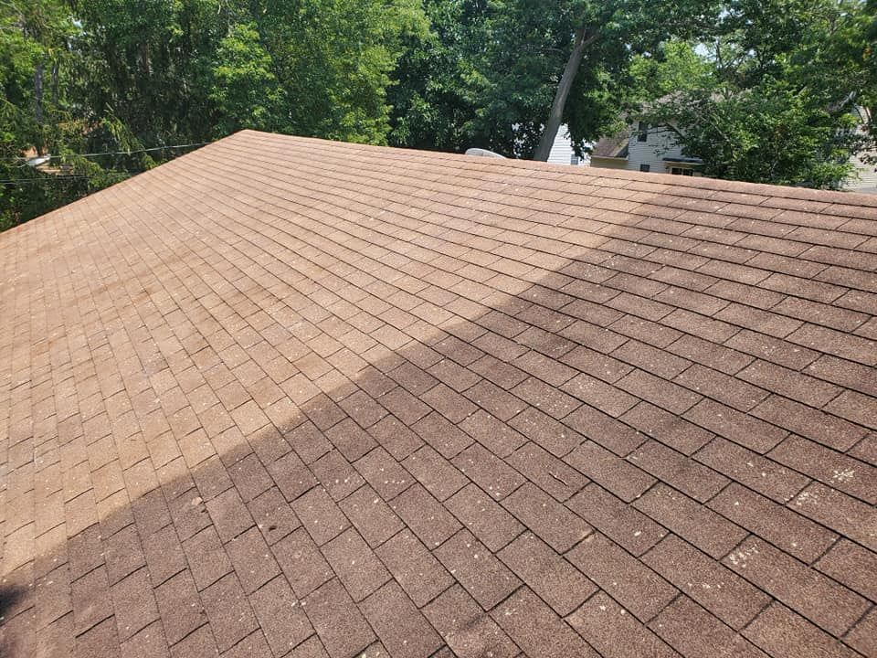 A picture of a roof before and after being cleaned.