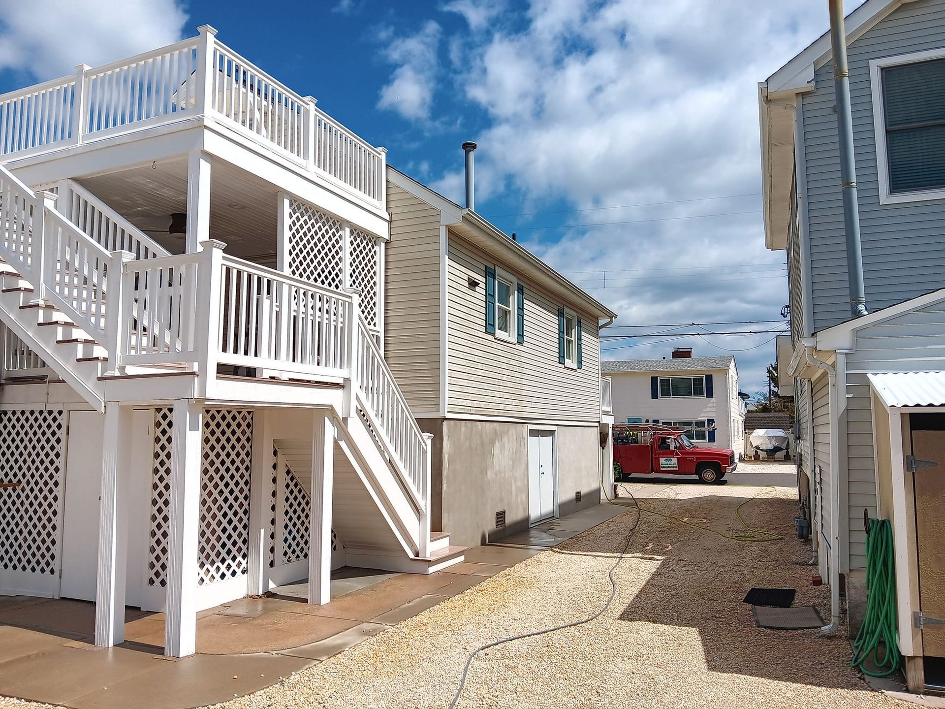 A white house with stairs leading up to the second floor
