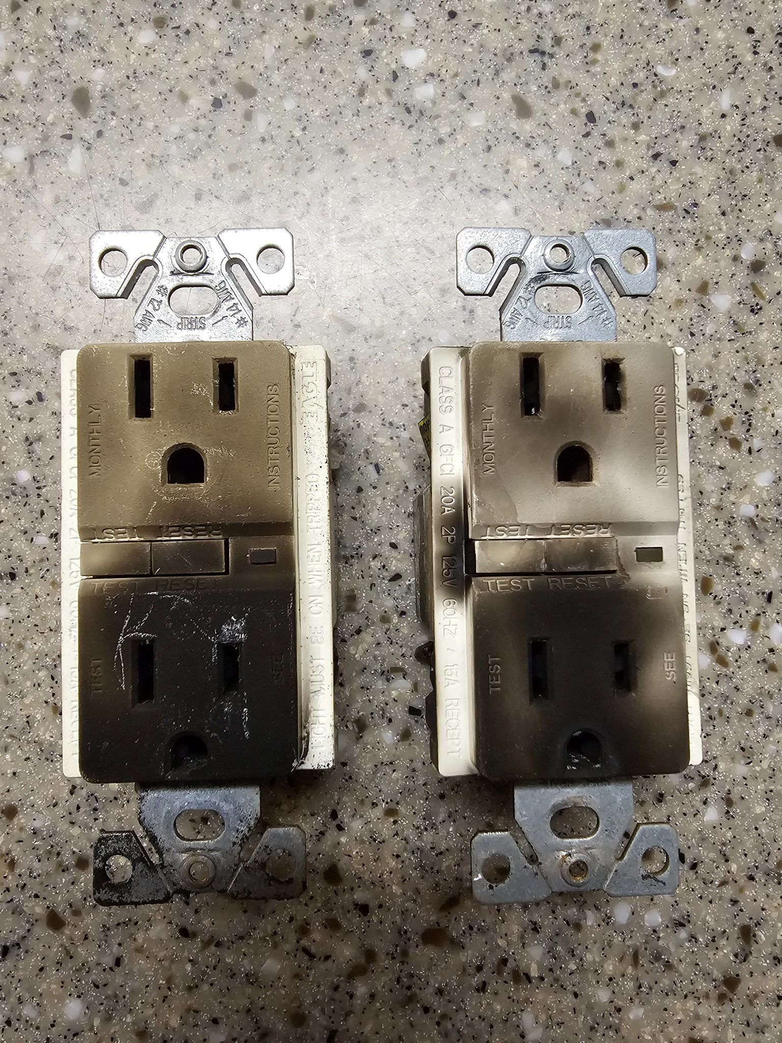Woman in straw hat smiles, holding wine glass near a lake.