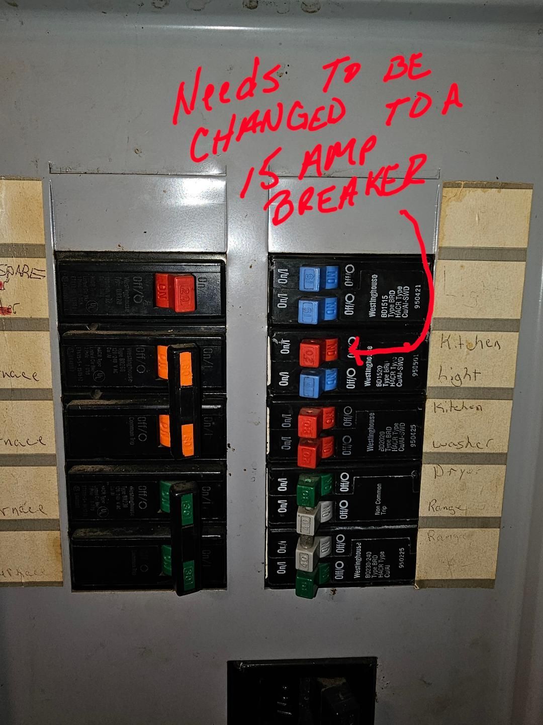 Woman in straw hat smiles, holding wine glass near a lake.