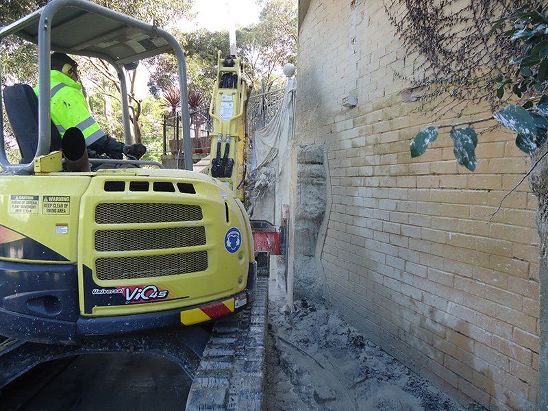 Hammer Breaking Rock — Woronora Heights, NSW — Mann's Earthmoving