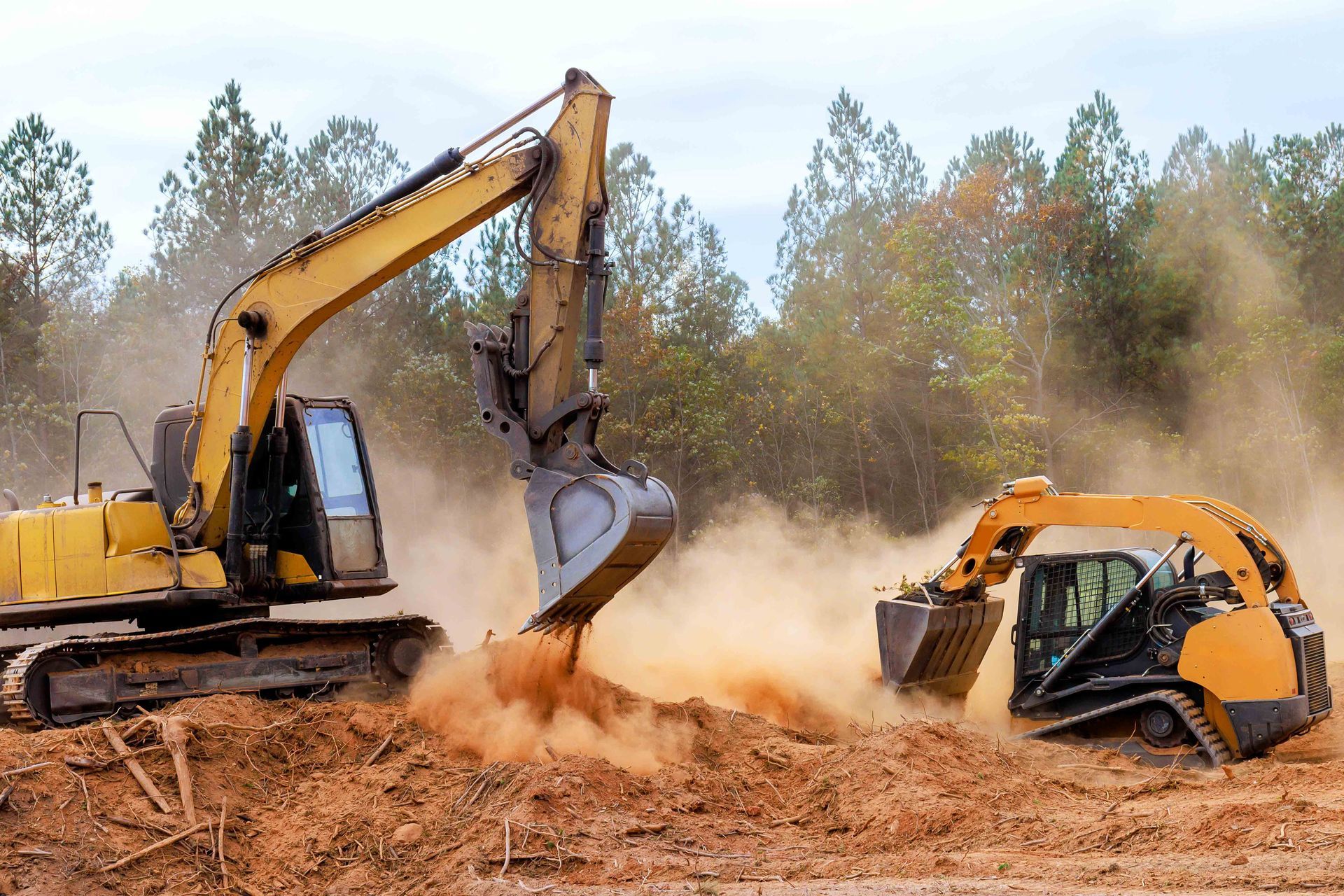 Excavator and bulldozer operating to prepare ground for construction project.