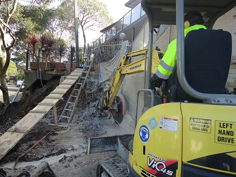 Rock Breaking with a Hydraulic Hammer — Woronora Heights, NSW — Mann's Earthmoving