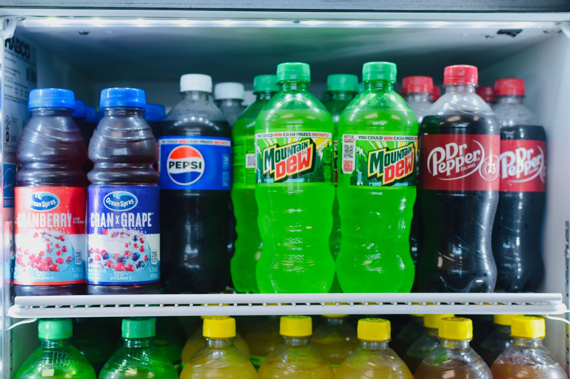 A glass of fresh orange juice with a splash, surrounded by oranges, with the words 