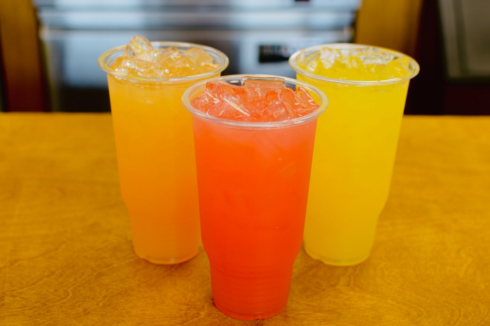 A glass of fresh orange juice with a splash, surrounded by oranges, with the words 