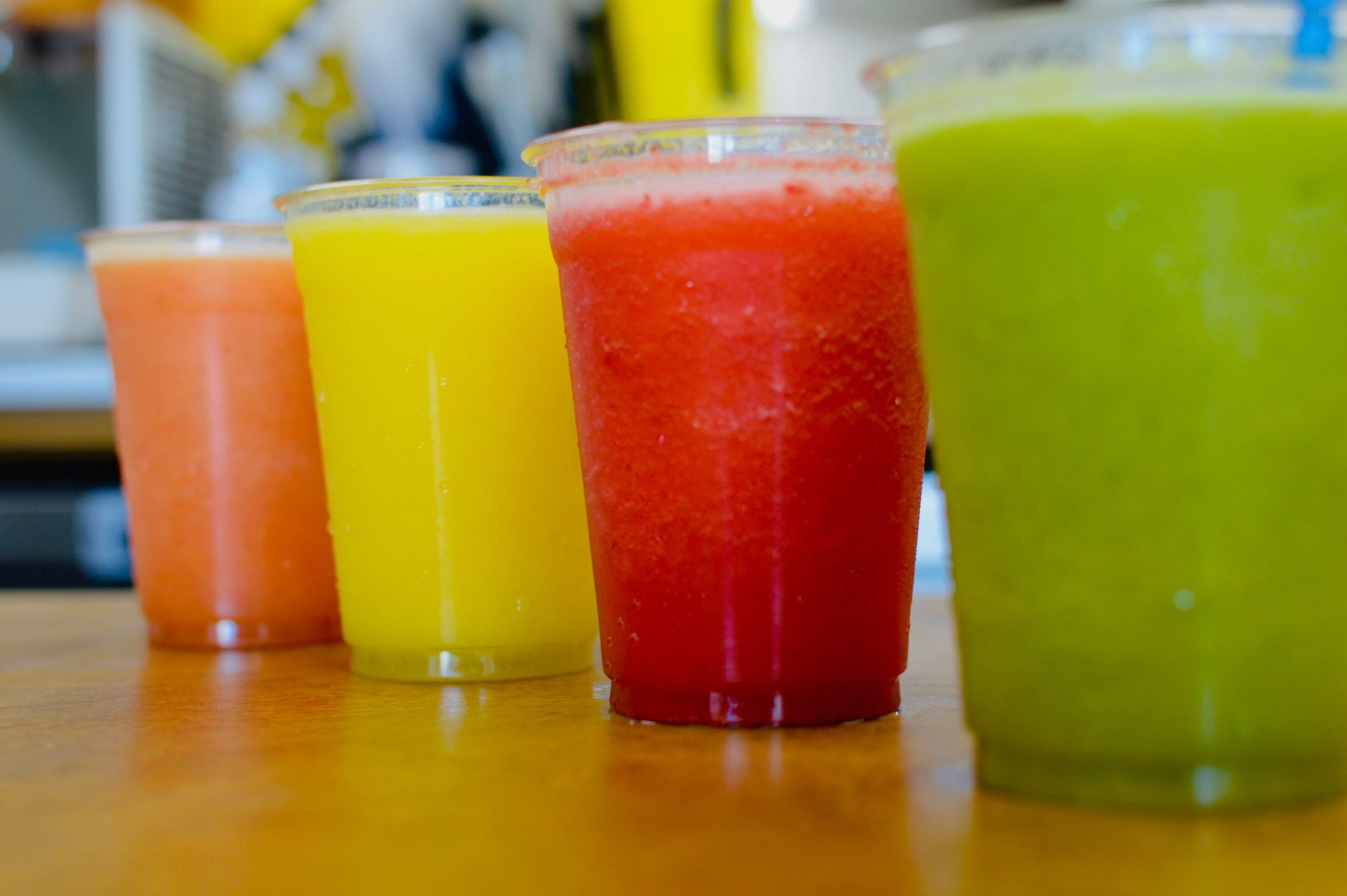 A glass of fresh orange juice with a splash, surrounded by oranges, with the words 