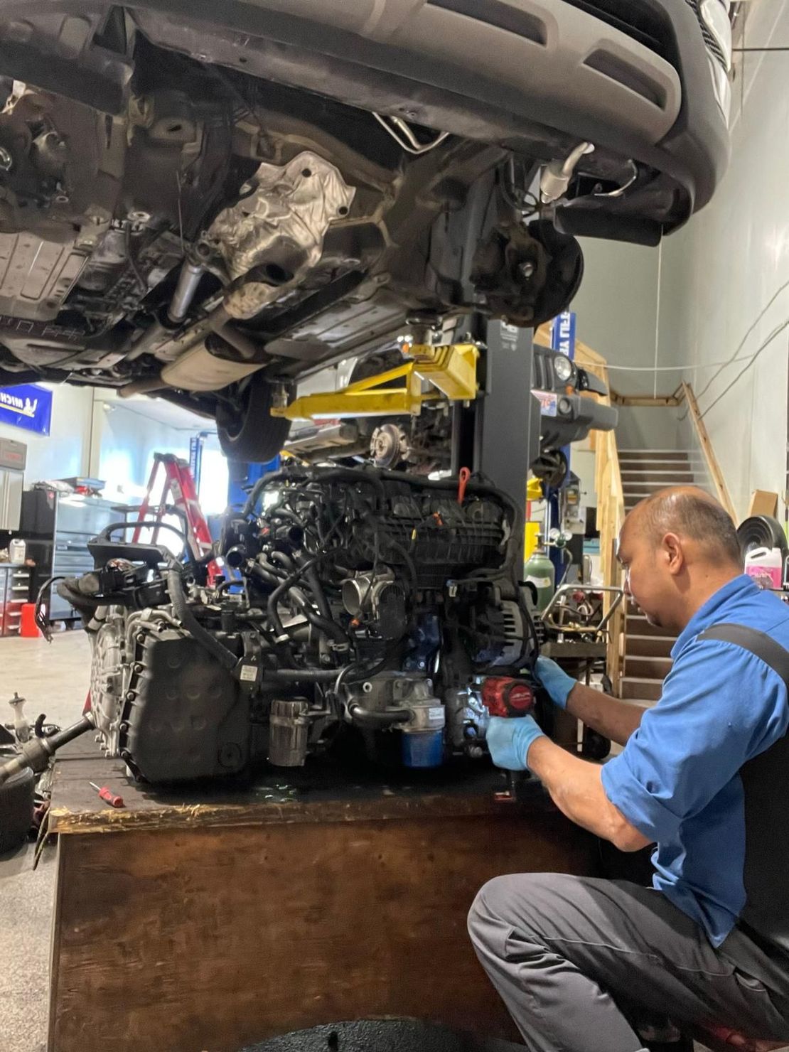 Expert Staff Performing Repair on Vehicle in Garage | Bruno Automotive