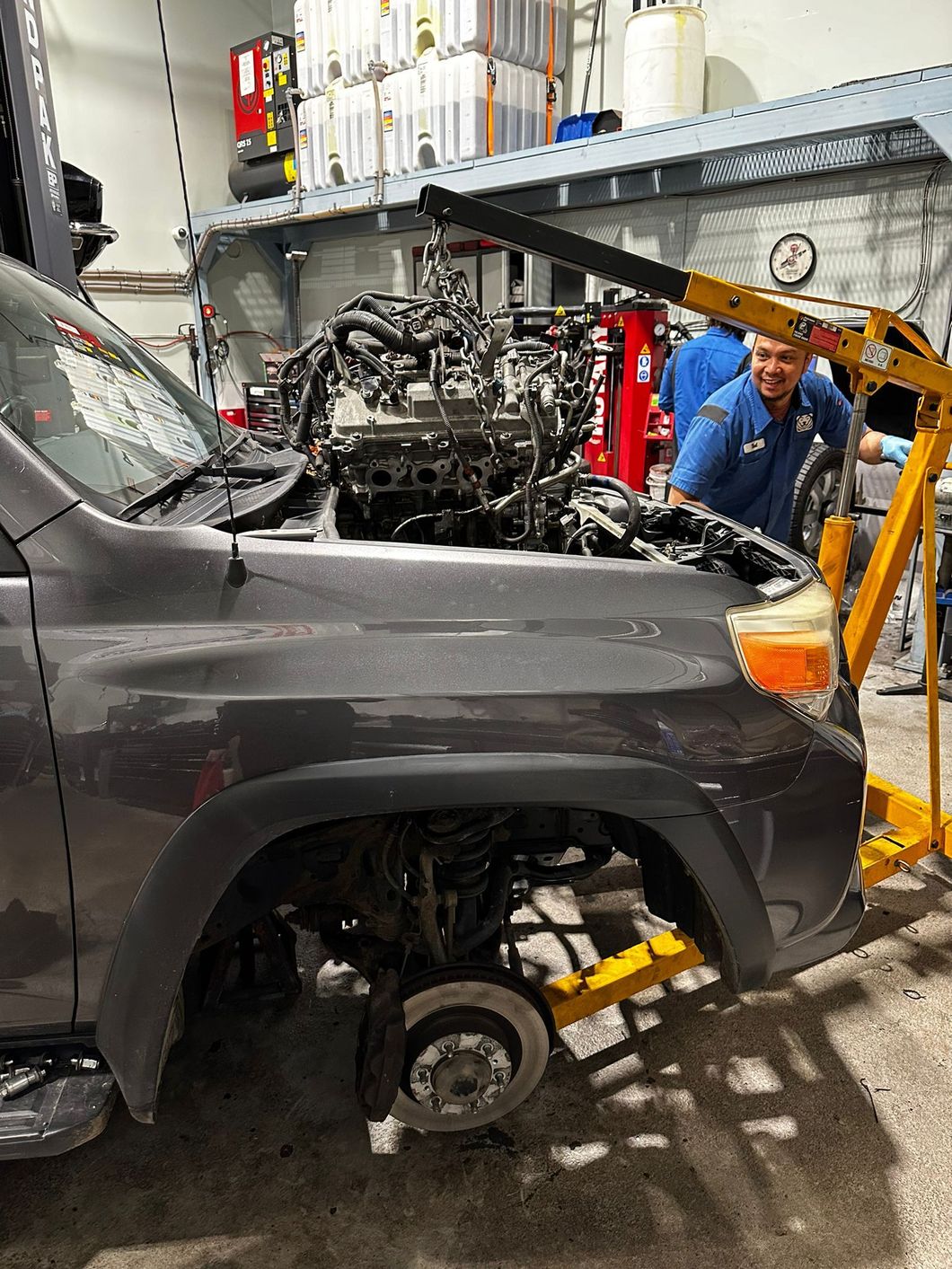 Expert Staff Repairing Car with Hood Open in Garage | Bruno Automotive