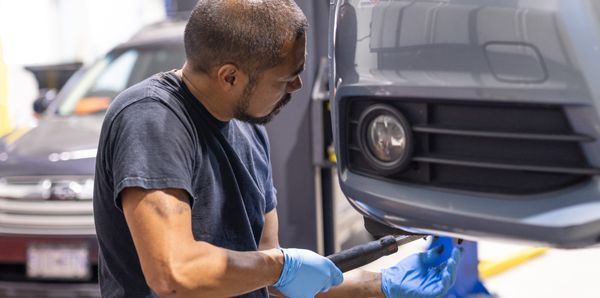 Expert Staff Performing Repair on Vehicle in Garage | Bruno Automotive