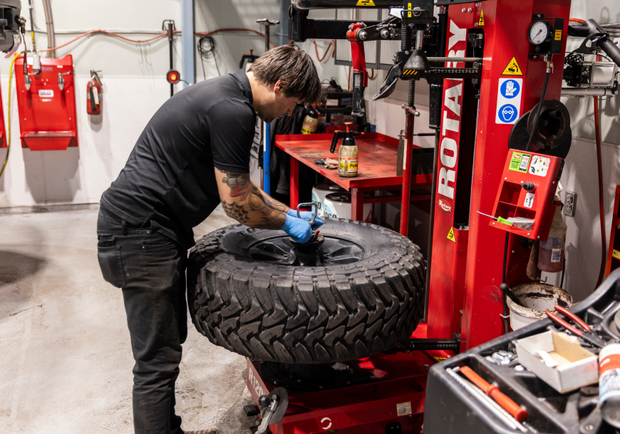 Expert Staff Working on Tire in Shop | Bruno Automotive
