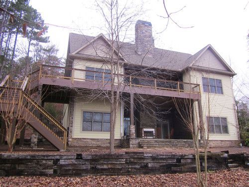 A large house with a large deck and stairs