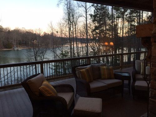 A deck with a view of a lake and trees