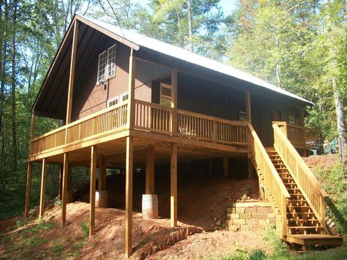 A house with a large deck and stairs leading up to it