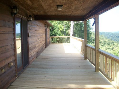 A large wooden deck with a view of the mountains