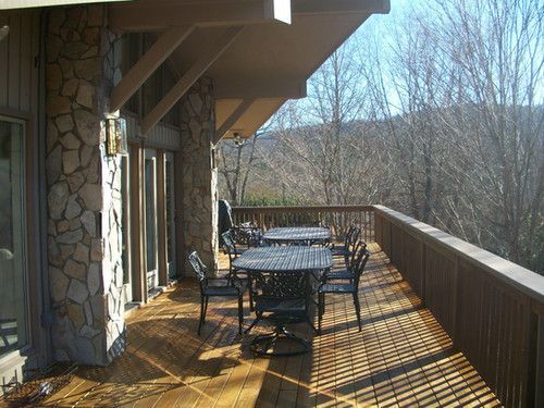 A large deck with tables and chairs on it