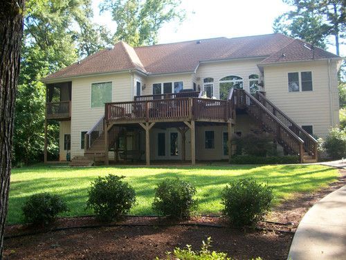 A large house with a large deck and stairs