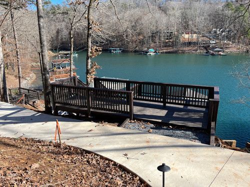 A wooden bridge over a body of water surrounded by trees.
