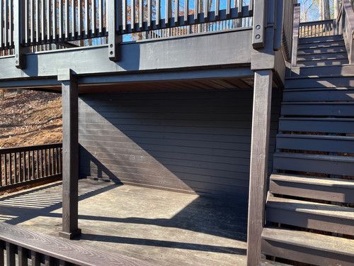 A wooden deck with stairs leading up to it.