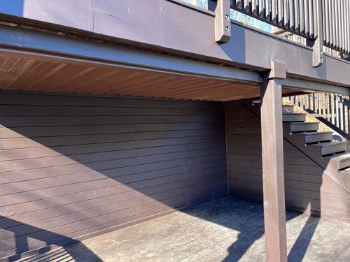 A wooden deck with stairs leading up to it.