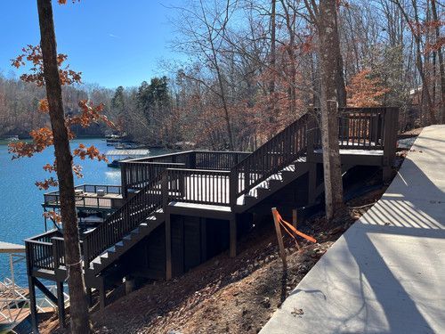 A staircase leading up to a deck overlooking a lake