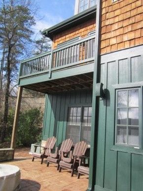 A house with a deck and chairs on it
