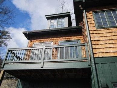A house with a balcony on the side of it