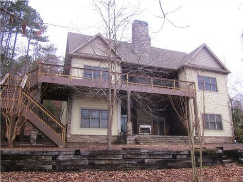 A large house with a large deck and stairs