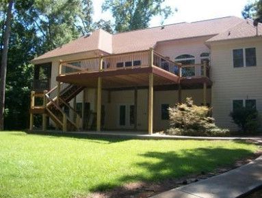 A large house with a large deck and stairs